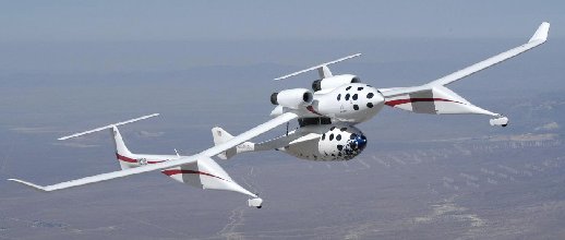 SpaceShipOne is carried to high altitude by the carrier aircraft White Knight during a test flight.